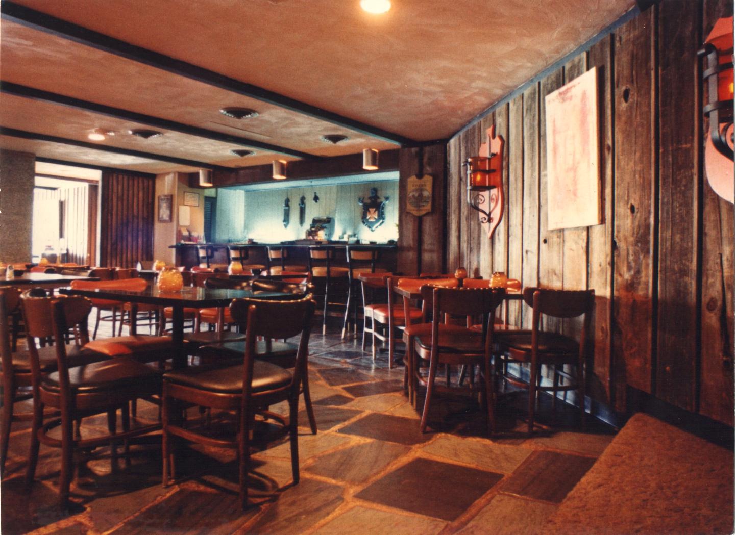 Club 96 wooden tables and chairs, warm lighting, and rustic decor.