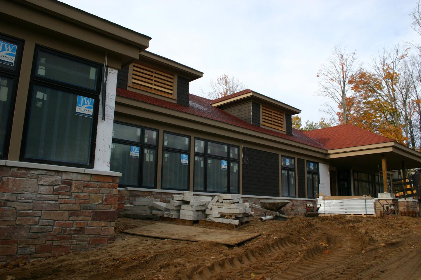 Construction site of Crystal Spa with large windows and a red roof.