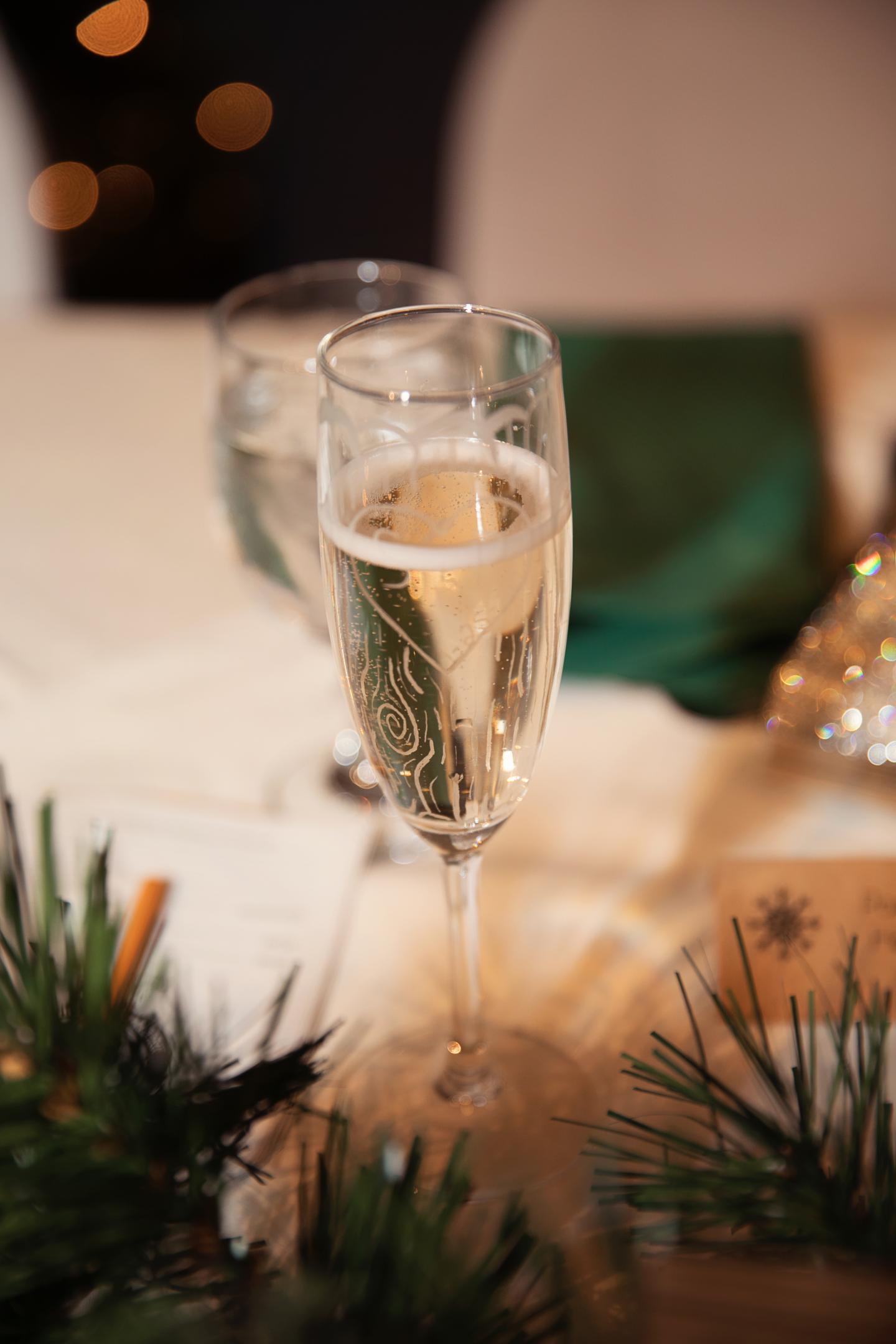 Champagne flute on a decorated holiday table.