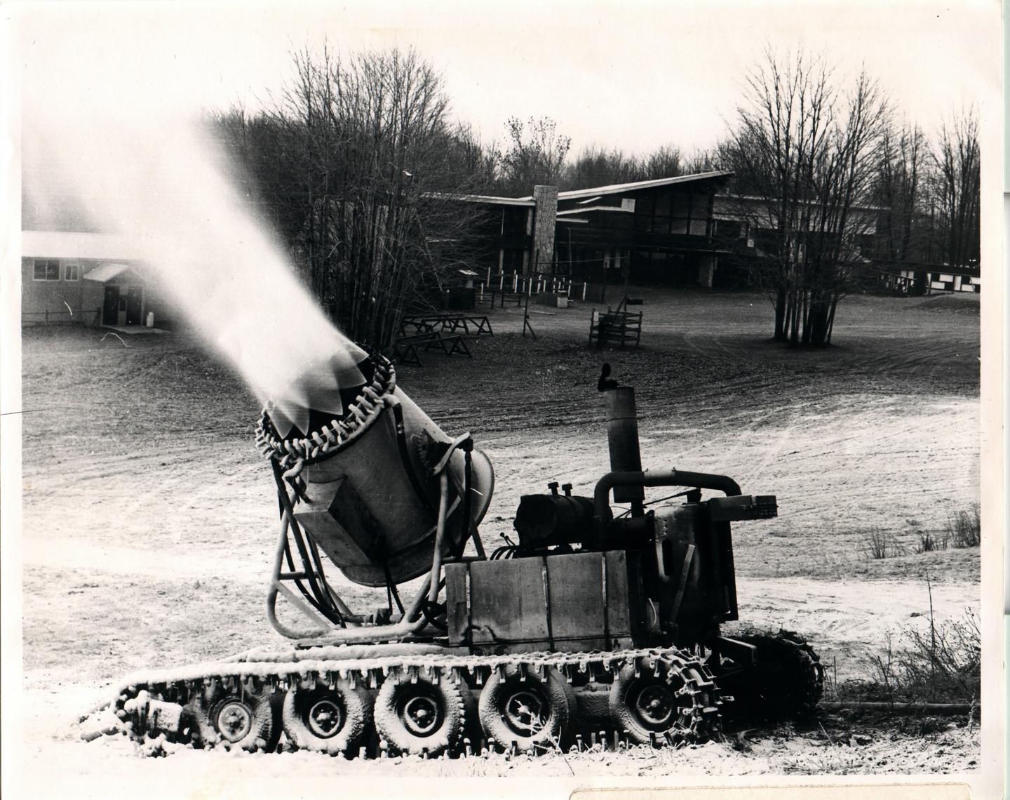 Historical snow machine spraying snow near the Lodge.