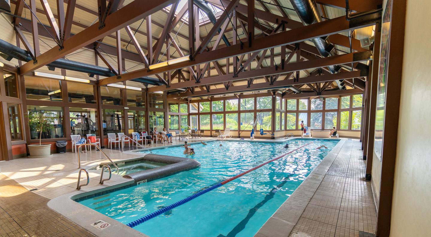 Indoor pool with large windows and natural light.