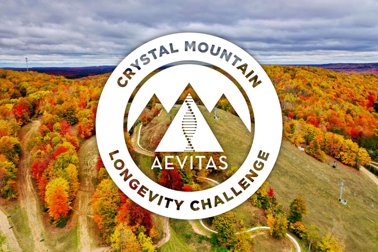 Autumn landscape with hills and colorful trees; circular logo overlay with "Crystal Mountain Aevitas Longevity Challenge."
