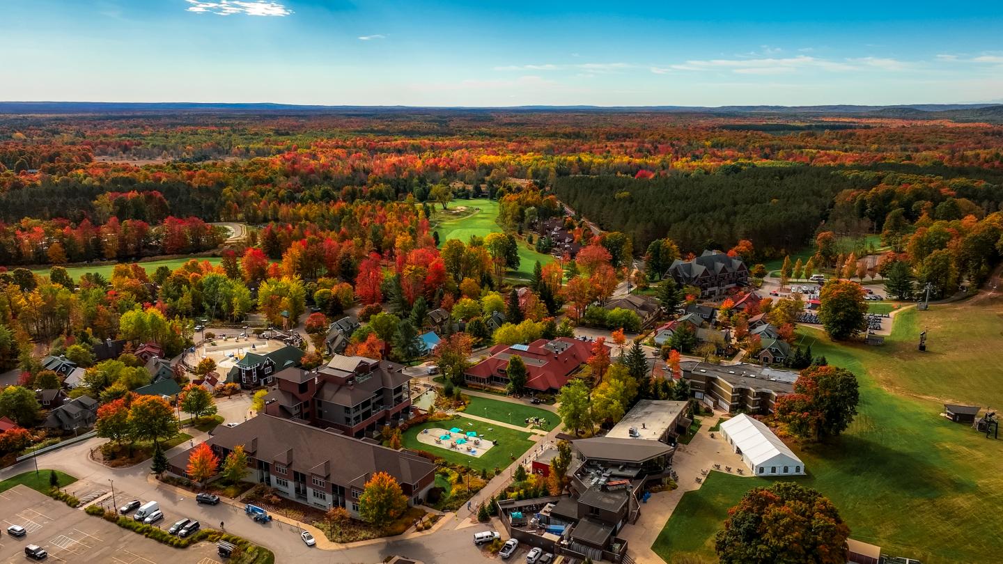 Aerial view of vibrant autumn trees around Crystal Mountain.