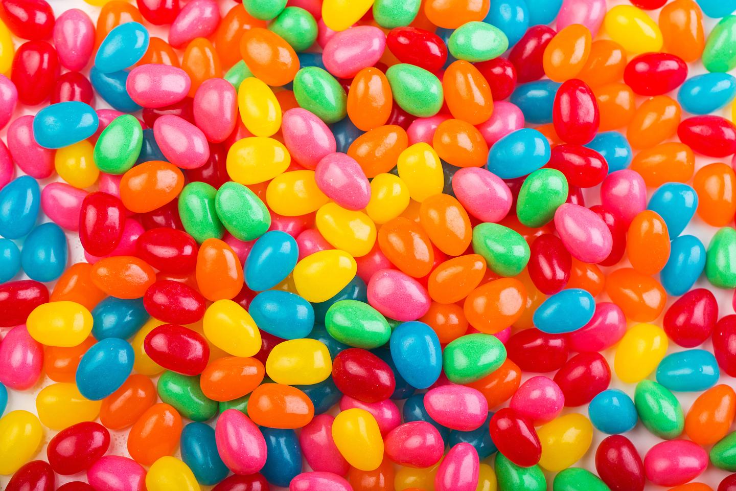 Assorted colorful jelly beans scattered closely together.