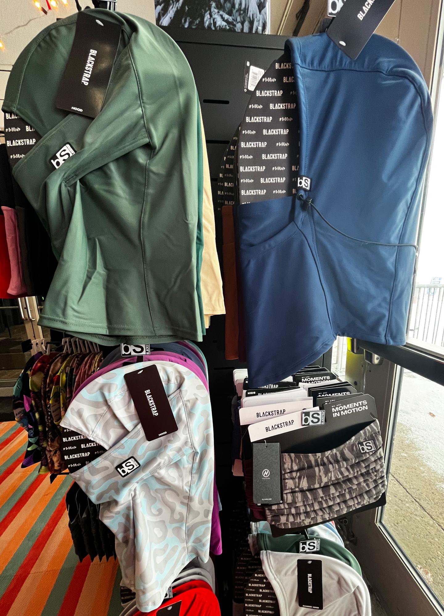 Clothing display with balaclavas in a store setting.