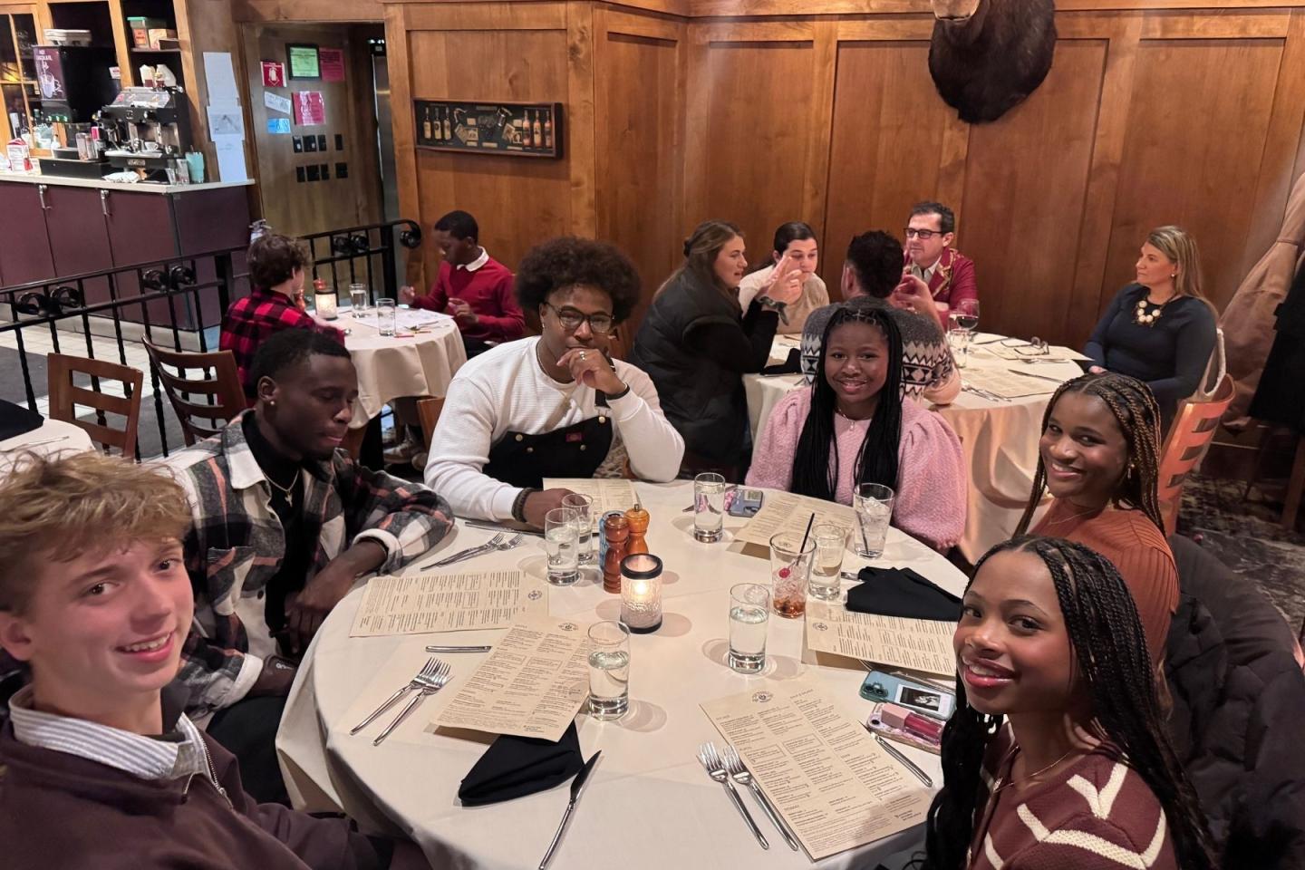 Family sitting at a round table in a restaurant.