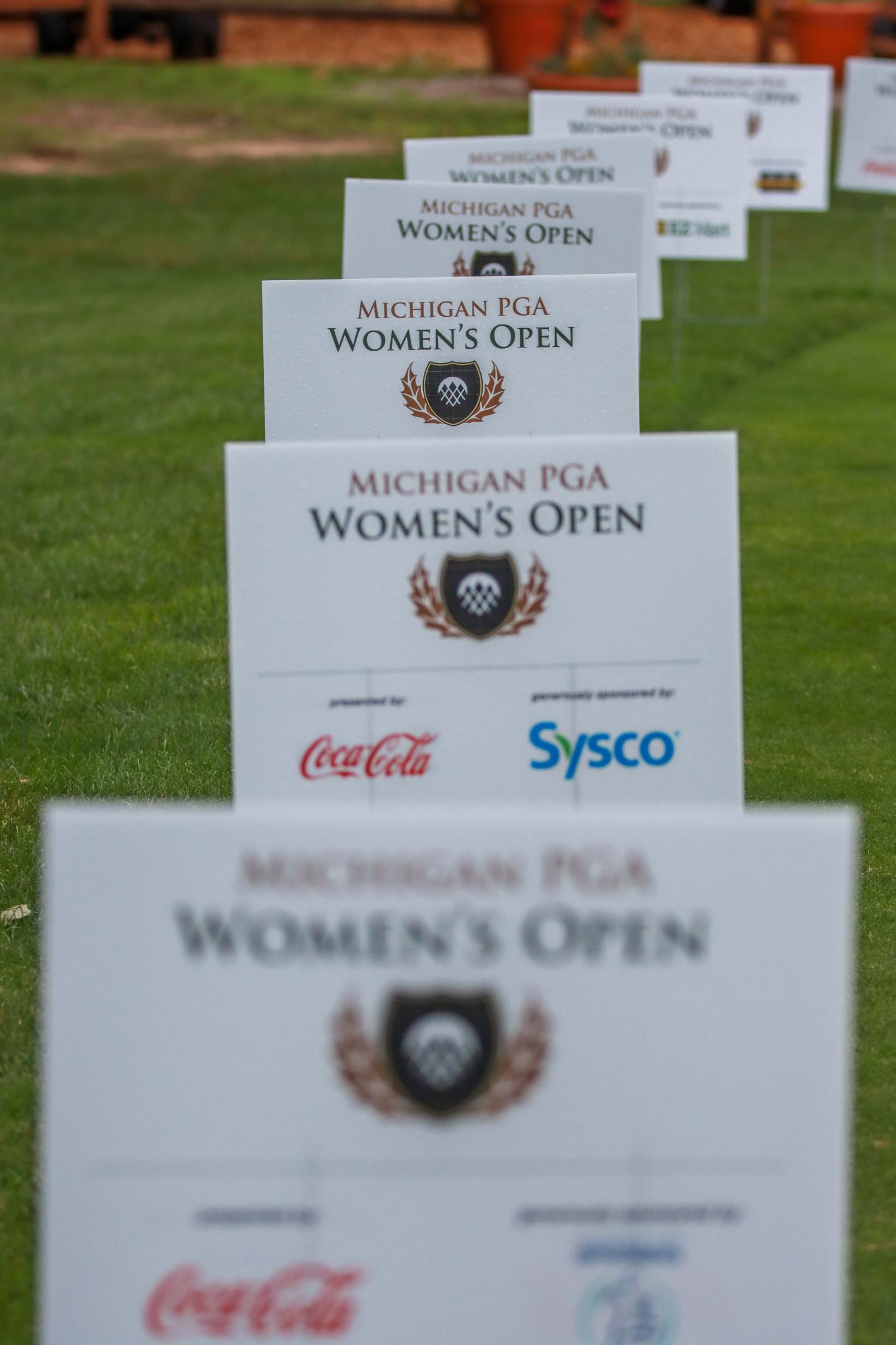 Signs on a golf course for the Michigan Women's Open.