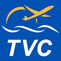 Blue logo with a yellow plane above stylized waves and the letters TVC.