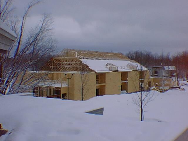 Building under construction in snowy landscape.